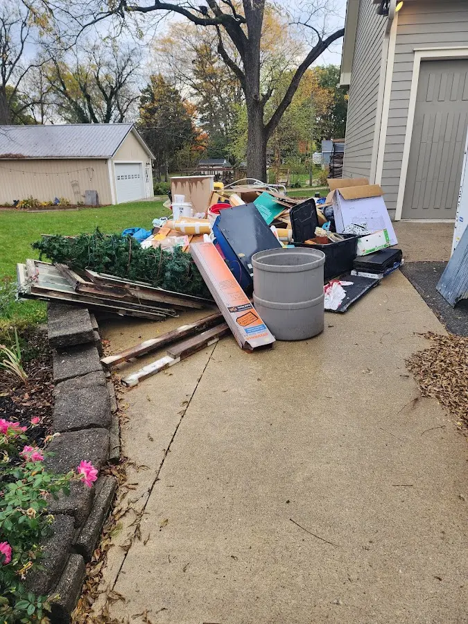 Dumpster being loaded with debris for 12 Yard Dumpster Rental in Olney